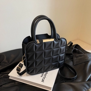 Elegant black quilted crossbody bag with golden metal buckle and rounded handles