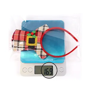 Plaid Christmas mini hat headband with holly berries detail on an electronic scale showing 16.9g