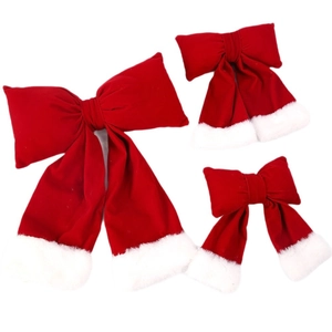 Three sizes of red velvet Christmas bows with white faux fur trim on white background