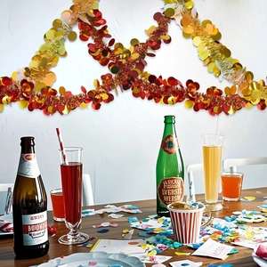 Macro view of 2m red and gold festive tinsel garland with shiny round sequins for party decor