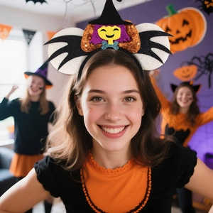 Detail of Halloween Mickey headband featuring a sequined witch hat and glittery bat wings