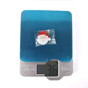 Detailed view of a Santa Claus acrylic clip on an electronic scale weighing 3.6 grams