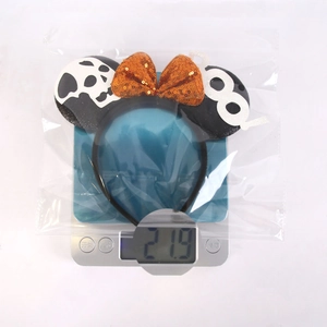 Detailed view of Halloween mouse ear headband with orange sequins and ghost detail