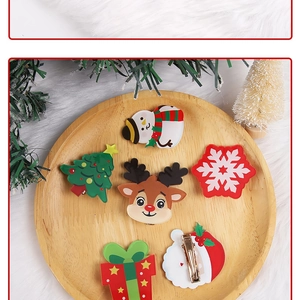 Detailed set of six acrylic Christmas hair clips featuring reindeer and Santa on a wooden tray