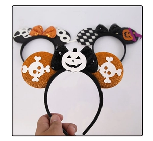 Detail of Halloween Mickey headbands with glitter ears and sequined pumpkin bows