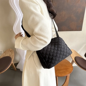 Quilted crossbody bag in black nylon with diamond stitch pattern and wide strap