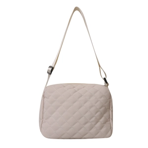 Quilted beige crossbody bag for women with minimalist diamond pattern and adjustable strap