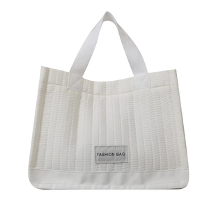 Minimalist white quilted tote bag with fashion tag and durable dual woven handles