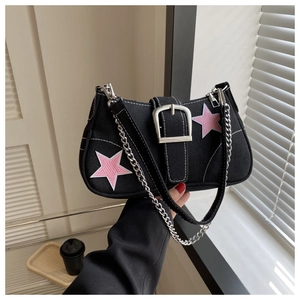 Detail of black canvas bag with pink stars, silver buckle and metallic chain strap