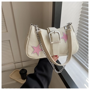 Close-up of canvas underarm bag with pink star embroidery and silver buckle detail