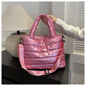 Detail of pink quilted tote bag with metallic finish and detachable woven strap