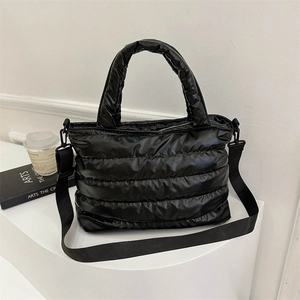 Large black quilted puffer tote bag with handles and detachable crossbody strap