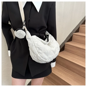 Detail of white quilted oxford cloth bag with a round coin purse on the strap