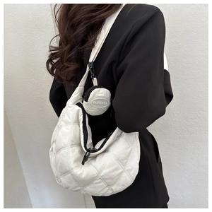 Detail of white quilted nylon hobo bag with round coin purse and wide shoulder strap