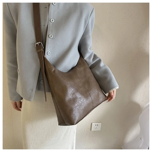 Brown vintage hobo shoulder bag detail featuring soft PU leather and adjustable wide strap