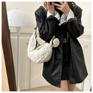 Close-up of white quilted hobo bag with matching detachable round coin purse charm