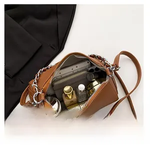 Internal view of a brown pebbled leather crossbody bag showing large storage capacity