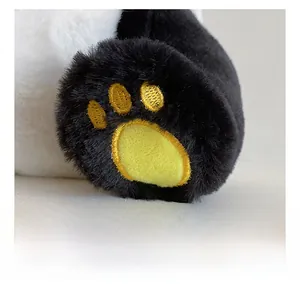 Close-up of golden embroidery on the soft plush panda foot with detailed stitching