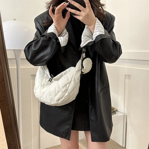 Quilted white crescent crossbody bag with small round pouch in puff puffer style
