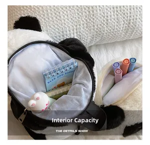 Macro detail of plush panda bag showing internal capacity with notebooks and stationery