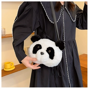 Detail view of a cute panda plush crossbody bag worn by a model in a minimal setting