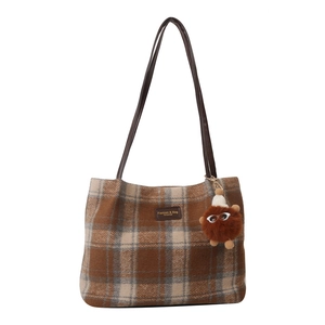 Winter checkered wool bucket tote bag with brown shoulder strap and furry monster charm