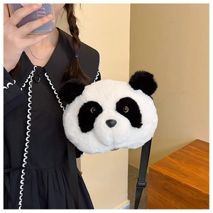 Detail of soft plush panda crossbody bag with adjustable strap worn by model