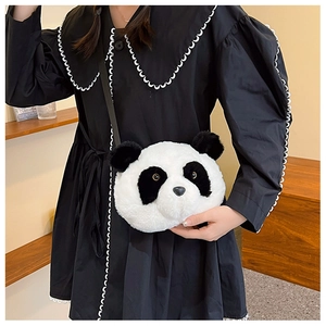 Close-up of fluffy panda plush crossbody bag with soft faux fur and long black strap