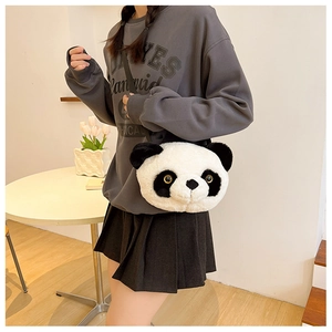 Detail of cute plush panda crossbody bag featuring soft fur and golden bead eyes
