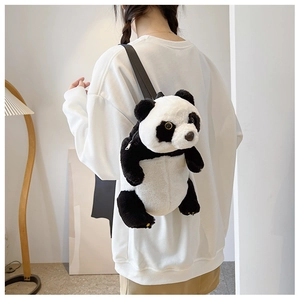 Detailed side view of a plush panda backpack with soft fur and leather straps on a model