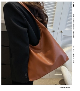 Close-up of tan PU hobo bag with litchi texture and soft draped design for daily commute