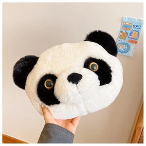 Close-up of cute plush panda shoulder bag with soft faux fur and realistic eye detail