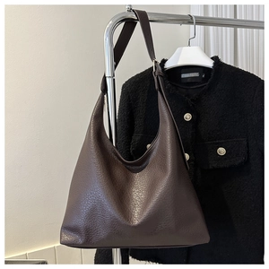 Close-up of the dark brown lychee pattern texture on this large capacity hobo shoulder bag