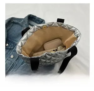 Internal view of silver quilted tote bag showing large capacity for essentials