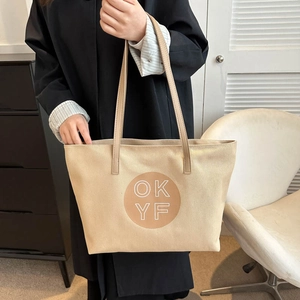 Minimalist beige canvas tote bag with OKYF letter print and shoulder straps for women