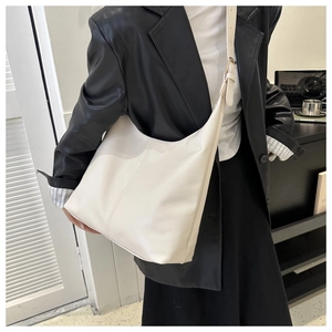Detailed view of the off-white minimalist crescent shoulder bag with adjustable buckle