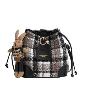 Classic tweed bucket bag with drawstring closure and cute knit rabbit charm accessory