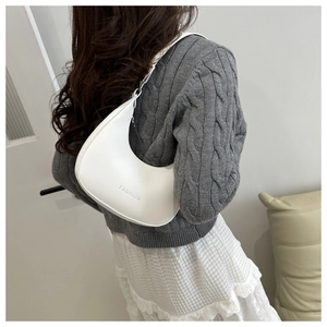 Detail shot of white half-moon underarm bag with Fashion lettering and slim strap