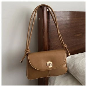 Classic caramel brown crossbody bag with gold turn-lock and knotted shoulder strap