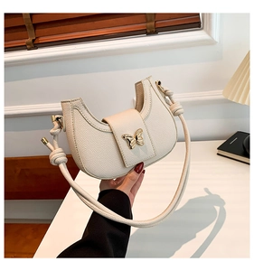 Chic beige half-moon shoulder bag with pebble texture and gold butterfly buckle