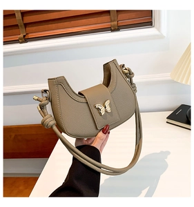 Khaki half-moon shoulder bag with golden butterfly clasp and knotted strap detail