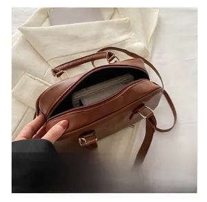 Interior view of brown PU leather boston bag showing zipper pocket and spacious capacity