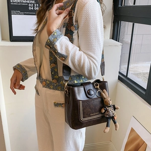 Retro dark brown bucket bag with wide bohemian strap and cute rabbit pendant charm
