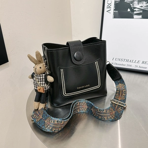 Fashion black PU leather bucket bag with wide ethnic strap and plush rabbit charm