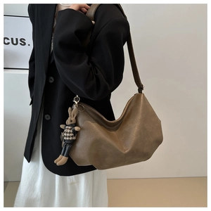 Braune Hobo-Tasche aus Leder mit niedlichem Hasenanhänger und Hahnentrittmuster-Detail