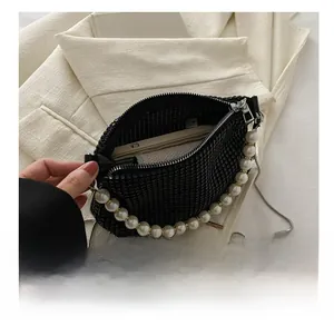 Detail of black rhinestone handbag showing interior capacity for phone and card holder