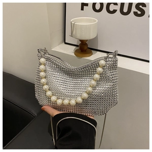 Detail view of silver sequin bag with sparkling rhinestones and pearl bead handle