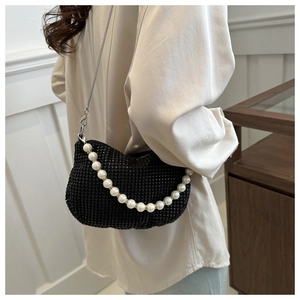 Detail of rhinestone evening bag with large pearl handle and silver chain strap