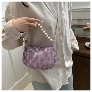 Detailed view of lavender rhinestone handbag with pearl handle and silver chain strap