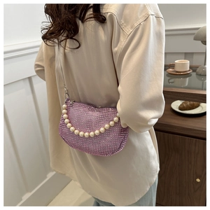 Detail of purple rhinestone shoulder bag with pearl handle and silver chain strap